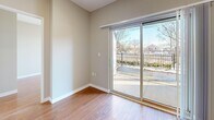 This well-laid-out 2-bedroom, 1-bathroom unit at 700 King St W offers a practical and comfortable single-floor living experience. Warm hardwood flooring runs throughout the main living areas and bedrooms, creating a cohesive and inviting atmosphere, while neutral grey walls provide a clean, versatile backdrop throughout.

The open living and dining area is bright and functional, featuring recessed pot lighting and a sliding glass door that leads directly to a private patio, offering outdoor views and filling the space with natural light. The kitchen is efficiently designed with rich dark-brown cabinetry, granite-style countertops, a stainless undermount sink, and black appliances including an electric range and refrigerator, all set on light ceramic tile flooring.

Both bedrooms are comfortably sized, with the primary bedroom featuring a large mirrored sliding door closet. The second bedroom also includes a sliding door closet and benefits from a large window that draws in ample natural light and outdoor views. The bathroom is finished with a clean white tile surround and a full soaker bathtub. Additional storage is provided through two closets, and a dedicated entrance area completes this practical and well-organized home.