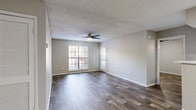 Located at 3101 Grand Pavilion Drive in Tampa, FL, this single-floor residence offers three bedrooms, two bathrooms, and a thoughtfully arranged layout. Rich wood-style flooring runs throughout the home, complemented by neutral gray walls and textured ceilings, creating a consistent and clean aesthetic across every room.

The open-concept living, dining, and kitchen area forms the heart of the home. The kitchen features white shaker cabinetry, light quartz-style countertops, a peninsula with a range hood overhead, stainless steel appliances, and a skylight that enhances natural brightness. The living and dining areas are generously proportioned, with ceiling fans and windows fitted with blinds allowing for natural light and airflow.

Each of the three bedrooms includes a ceiling fan, window with blinds, and wood-style flooring. The primary bedroom offers a comfortable footprint with direct closet access. The additional bedrooms are well-sized, with one featuring a louvered bi-fold closet. A total of three closets provides ample storage throughout.

Both bathrooms are finished with white tile tub-shower combinations, light countertops, white cabinetry, and matching wood-style flooring. A utility room and a private balcony round out the functional features of this well-appointed Tampa residence.