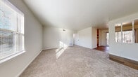Located at 2629 Suffolk Ave in High Point, NC, this single-floor residence offers three bedrooms, two bathrooms, a living room, kitchen, hallway, and pantry within a well-organized layout. The spacious living room features neutral carpet flooring and clean white walls that allow natural light to fill the room, creating a bright and open atmosphere. A transition to wood-look flooring marks the entrance to the kitchen and bathrooms, providing a practical and cohesive design throughout. The kitchen is equipped with gray cabinetry, white countertops, and white appliances including a refrigerator, dishwasher, and electric range, offering ample storage and counter space for everyday use. The primary bedroom is generously sized, with large windows that invite natural light and provide outdoor views. The additional bedrooms are carpeted and well-proportioned, each featuring closet access. Both bathrooms are finished with wood-look flooring; one includes a white vanity with a dark-framed mirror and matte black fixtures, while the other features a bathtub and toilet in a clean, functional layout. The hallway connects the rooms efficiently, and a dedicated pantry adds convenient storage. The overall ambiance is clean, neutral, and move-in ready.