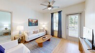 Located at 1000 Sweetbay Haven Ln in Apex, NC, this well-appointed 2-bedroom, 2-bathroom residence offers a thoughtfully designed single-floor layout. The open-concept living, dining, and kitchen area forms the heart of the home, bathed in natural light from multiple windows framed by elegant draping curtains. Light wood flooring flows seamlessly throughout the main living spaces, enhancing the bright, airy atmosphere. Ceiling fans provide added comfort in both the living room and bedrooms.

The kitchen is outfitted with crisp white shaker cabinetry, granite countertops, stainless steel appliances including a refrigerator, range, and microwave, and a pantry for extra storage. The dining area comfortably accommodates a full table and chairs, making it ideal for everyday meals or entertaining.

Both bedrooms feature plush carpeting and ample closet space, with the primary bedroom offering a generously sized layout. The two bathrooms are finished with white cabinetry, granite-topped vanities, and wood-look flooring. One bathroom includes a shower/tub combination, while the other features a walk-in shower. Additional conveniences include in-unit laundry, a utility room, and a private balcony accessible from the living area.