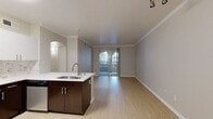 Located at 730 Agnew Road in Santa Clara, California, this well-appointed single-story apartment offers 680 square feet of thoughtfully designed living space, encompassing one bedroom, one bathroom, a kitchen, and a dedicated closet. Light wood-style flooring flows consistently throughout the unit, creating a clean, cohesive aesthetic.

The kitchen is a standout feature, showcasing a two-tone design with crisp white upper cabinetry and rich dark lower cabinets, complemented by white quartz countertops and a marble-style tile backsplash. Stainless steel appliances — including a gas range, built-in microwave, dishwasher, and full-size refrigerator — provide a fully equipped cooking environment. A kitchen island with an integrated sink adds both prep space and functionality. An elegant arched doorway connects the kitchen to the living area, lending architectural character to the open layout.

The primary bedroom spans 220 square feet and features a large window that admits generous natural light, along with access to a dedicated closet with built-in shelving. The bathroom is fitted with a full soaking tub and shower combo, a dark-toned vanity, and light wood-style flooring. Neutral wall tones throughout the unit contribute to a calm, versatile ambiance well-suited for modern living.