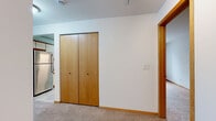 Located at 806 Riverwalk Dr in Waukesha, Wisconsin, this one-bedroom, one-bathroom residence offers a well-organized single-floor layout with a clean, functional design throughout. The open-plan living and dining area is generously sized, featuring plush carpeted flooring, track lighting, and a sliding glass door that fills the space with natural light and provides access to an outdoor balcony with views of surrounding greenery.

The kitchen is a standout feature, boasting abundant white cabinetry with warm wood trim accents, ample counter space, and a skylight overhead that bathes the room in natural light. It is equipped with a stainless steel range, dishwasher, and refrigerator, all set above easy-care tile flooring.

The bedroom is comfortably sized, featuring soft carpeting, a window with outdoor views, and a full-width double closet with warm wood-toned bi-fold doors. Additional storage is provided by a second closet accessible from the hallway.

The bathroom is clean and practical, featuring tile flooring, a full tub-shower combo, a vanity with storage, and a mirror. Throughout the residence, warm wood baseboards and trim provide a consistent, cohesive aesthetic against the neutral white walls.