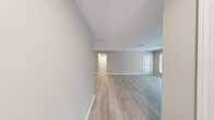 Located at 2000 Colony Park Drive in Birmingham, Alabama, this one-bedroom, one-bathroom residence offers a well-designed single-floor layout that maximizes comfort and functionality. The open-concept living room is bright and welcoming, featuring light hardwood-style flooring, a ceiling fan, large windows that invite abundant natural light, and a tile-surround fireplace that serves as a natural focal point. A sliding glass door leads to a private balcony overlooking a lush, tree-lined landscape, providing a serene outdoor retreat. The galley-style kitchen is thoughtfully appointed with white shaker cabinetry, granite countertops, stainless steel appliances including a refrigerator and dishwasher, and light wood-look flooring that ties seamlessly into the living area. The bedroom is a comfortable, carpeted retreat equipped with a ceiling fan and a window allowing natural light to filter in. The full bathroom features a granite-topped vanity with white cabinetry, a shower/tub combination, and wood-look flooring for a clean, cohesive finish. A dedicated closet and hallway complete the layout, offering practical storage solutions. Neutral tones throughout the space create a calm, move-in-ready atmosphere.