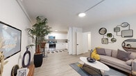 Located at 475 N Granada Ave in Tucson, Arizona, this single-floor residence offers a thoughtfully designed layout with a clean, contemporary aesthetic throughout. Light-toned luxury vinyl plank flooring flows seamlessly across the entire unit, contributing to a bright and cohesive feel.

The open-concept living and kitchen area forms the heart of the space. The kitchen is outfitted with stainless steel appliances — including a refrigerator, range, and over-the-range microwave — complemented by sleek white cabinetry, light countertops, and a subtle tile backsplash. A dedicated dining nook with a marble-top table sits adjacent to the kitchen, making the space both functional and inviting.

The living room features a large window that allows generous natural light to fill the room, creating an airy atmosphere. A decorative arrangement of mirrors on the accent wall adds visual interest and depth.

The bedroom is a well-proportioned retreat with a ceiling fan, a large window with natural light, and a spacious walk-in closet with built-in hanging rods and ample storage. The bathroom is finished with a white vanity, light countertop, tub-shower combination, and dark-accented open shelving for a modern touch.

Throughout the unit, white walls and neutral finishes provide a versatile, move-in-ready backdrop.