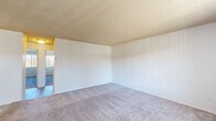 Located at 1707 La Brea St in Ramona, CA, this 2-bedroom, 2-bathroom unit offers a practical and well-organized single-floor layout. The kitchen is bright and functional, featuring white cabinetry, white appliances including a range, dishwasher, and refrigerator, light wood-look flooring, and a window that allows natural light to fill the space. The living area is carpeted and generously proportioned, with textured ceilings and neutral white walls that create a clean, versatile backdrop. Both bedrooms are carpeted and finished with the same neutral palette, offering comfortable, quiet spaces. The primary bedroom is notably spacious, with room for a full furniture arrangement, and includes a window with vertical blinds that brings in outdoor views. Each bedroom is served by its own closet. The two full bathrooms are consistently appointed, each featuring a tub-shower combination, wood-look tile flooring, a white vanity with a marble-style countertop, and brushed nickel fixtures. The overall ambiance of the unit is clean, bright, and move-in ready, with a straightforward layout that maximizes usability throughout.