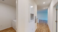 Located at 117 Bayvista Dr in Port Royal, SC, this well-designed 2-bedroom, 1-bathroom single-story home offers a clean, contemporary aesthetic throughout. Light-toned luxury vinyl plank flooring runs continuously through the space, creating a cohesive and easy-to-maintain foundation in every room.

The open-concept kitchen and living area serves as the heart of the home. The kitchen is outfitted with modern gray cabinetry, granite countertops, a white subway tile backsplash, and a full suite of stainless steel appliances including a French door refrigerator, electric range, built-in microwave, and dishwasher. A peninsula with pendant lighting provides additional prep space and casual seating. The adjacent living area features a ceiling fan and a sliding glass door that invites natural light and outdoor access.

The primary bedroom is generously sized, featuring multiple windows with blinds, a ceiling fan, and ample natural light. The second bedroom also includes a ceiling fan, a window, and closet access. Both rooms share a well-appointed full bathroom with granite countertops, gray cabinetry, a large framed mirror, and a tiled tub-shower combination.

A dedicated laundry room with a full-size washer and dryer and a wire shelving unit adds everyday convenience to this thoughtfully laid-out home.
