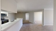 This 870 square foot single-story residence in Greenacres, Florida offers a practical and efficient living space. The home features three bedrooms, including a primary bedroom of 150 square feet, and one full bathroom. The kitchen has been updated with modern white cabinetry, stainless steel appliances, and a convenient breakfast bar that opens to the living area. Neutral-toned walls and carpeting throughout most rooms create a cohesive look, while the kitchen boasts wood-look flooring for easy maintenance. Large windows in the bedrooms allow for ample natural light, and ceiling fans provide additional comfort. The bathroom features a single vanity and combination tub/shower. A dedicated laundry area adds functionality to the home. The open floor plan maximizes the use of space, making the home feel larger than its square footage suggests. Located at 50 Olive Tree Circle, this property combines practicality with modern touches, ideal for those seeking an affordable yet comfortable living space in Florida.