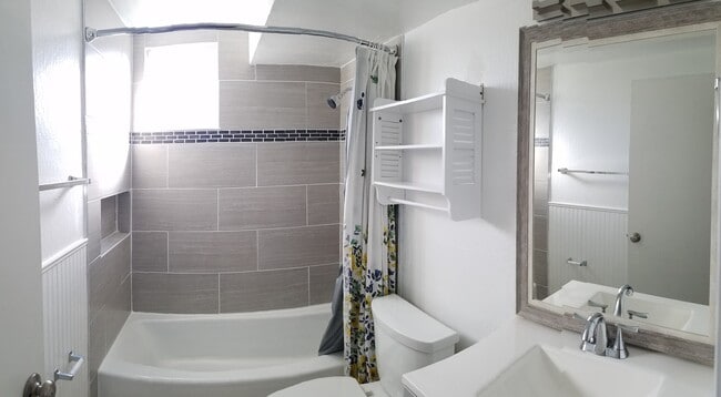 Bathroom just received a nice facelift which includes an updated vanity, low flow toilet, and large format tile shower over tub - 830 Spruce Ct