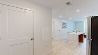 Located at 523 Chestnut Ave in Woodbury Heights, NJ, this well-appointed 2-bedroom, 2-bathroom residence offers a thoughtfully designed single-floor layout with modern finishes throughout. Light wood flooring flows seamlessly across the entire space, creating a cohesive and airy feel.

The kitchen is a standout feature, showcasing floor-to-ceiling white cabinetry, a striking marble-veined waterfall island, stainless steel appliances including a gas range and refrigerator, and a clean white quartz countertop — all combining to create a sleek, functional cooking space.

The living room benefits from large windows that invite natural light and offer outdoor views, lending the area an open, welcoming atmosphere. The spacious primary bedroom includes a double-door closet and its own large window with outdoor views, while a hallway leads conveniently to an en-suite bathroom. The second bedroom is equally well-lit with generous window placement.

Both bathrooms are finished in a clean, contemporary style with white cabinetry, framed mirrors, soaking tub-shower combinations, recessed lighting, and tall linen storage towers. A dedicated hallway and closet provide additional storage and circulation throughout the residence, completing a practical and polished living environment.