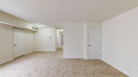 This single-floor residence in Glen Burnie, Maryland, offers a straightforward and functional layout across three bedrooms, one bathroom, a kitchen, living room, and a dedicated laundry area. The living room greets you at the entry with a large window that draws in natural light, neutral-toned carpet flooring, and clean white walls that lend a bright, open feel throughout. Panel-style interior doors and ceiling-mounted light fixtures are consistent design elements found throughout the home. Each of the three bedrooms features wall-to-wall carpet and neutral walls. The primary bedroom provides a comfortable footprint with a closet and window for natural light, while the additional bedrooms are well-sized with windows and standard closet access. The kitchen is equipped with warm oak cabinetry, stone-patterned countertops, a dishwasher, and a refrigerator, all set on light wood-look flooring that adds a clean, practical finish. The full bathroom includes a tiled tub-and-shower combination, a wood-vanity with sink, and light wood-look tile flooring, maintaining a clean and functional aesthetic. A dedicated laundry space adds everyday convenience to this well-organized home.