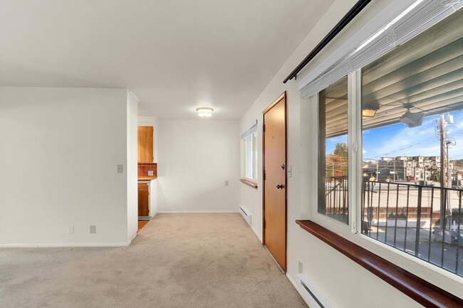 Loving room looking into dining area. - Birch Tree Apartments