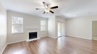 Located at 6301 Stonewood Dr in Plano, TX, this two-story, 3-bedroom, 2-bathroom home offers a well-organized layout across two levels. The main living area features an open-concept kitchen and living room with light hardwood-style flooring, crown molding, and recessed lighting. The kitchen is equipped with warm-toned wood cabinetry, granite countertops, white appliances including a range, dishwasher, and refrigerator, and a peninsula that provides additional counter space and separation from the living area. A sliding glass door in the living room opens to a covered balcony with views of the surrounding neighborhood. The three bedrooms are carpeted and fitted with ceiling fans, offering comfortable, well-lit spaces with natural light from windows dressed with blinds. The spacious primary bedroom includes a walk-in closet with wire shelving. The two bathrooms feature granite countertops, white cabinetry, and hardwood-style flooring, with one bathroom offering a tub-shower combination with tiled surround. Additional highlights include multiple closets, a hallway, a utility room, and an attached garage with concrete flooring. The home's neutral color palette and clean finishes create a bright, functional living environment throughout.