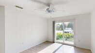 Located at 5335 Hawks Landing Dr in Fort Myers, Florida, this single-story, 3-bedroom, 2-bathroom home offers a practical and well-organized layout. The interior is finished with light wood-style flooring in the main living areas, creating a clean, cohesive look throughout.

The kitchen features warm-toned wood cabinetry, granite-look countertops, and white appliances including a range, dishwasher, and refrigerator. It opens directly into the living room, enhancing the sense of flow between spaces. The living room is bright and airy, with a ceiling fan and a sliding glass door that invites natural light and provides views of the surrounding greenery.

The three bedrooms include a generously sized primary bedroom with its own ceiling fan and a large window with lush outdoor views. The additional bedrooms feature carpet flooring and include closet storage. A dedicated closet space with wire shelving provides additional storage capacity.

Both bathrooms are finished with clean white tile surrounds and include full tub-shower combinations. Wood-look tile flooring in the bathrooms complements the home's consistent design aesthetic. Louvered closet doors add a classic touch to one of the bathrooms. The home's bright, neutral palette and functional layout make it a comfortable and practical residence in the heart of Fort Myers.