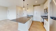 This efficient 600 square foot apartment maximizes space with a thoughtful layout. The single-floor design incorporates one bedroom (120 sq ft), one bathroom, and an open-concept living area. The modern kitchen is a standout feature, boasting sleek white cabinetry, stainless steel appliances, and a spacious island with a sink and additional storage. Pendant lighting adds a touch of elegance to the kitchen space.

The bedroom, while compact, offers plush carpeting and a large window for natural light. The bathroom features light wood flooring, a single vanity, and a toilet. Throughout the apartment, neutral tones create a bright and airy atmosphere, with beige walls and white trim.

Large windows in the living areas and bedroom provide ample natural light and potential views. The apartment also includes a closet for additional storage. Recessed lighting in the kitchen and living areas complement the overall modern aesthetic. This well-designed space efficiently accommodates all essential living needs within its compact footprint.