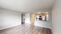 Located at 287 W Johnstown Rd in Gahanna, Ohio, this single-floor home offers a clean, modern aesthetic throughout its thoughtfully updated interior. The open living area is finished with light-toned luxury vinyl plank flooring and soft gray walls, creating a bright and welcoming atmosphere enhanced by a large front-facing window that draws in natural light. A built-in closet provides convenient storage directly off the living space.

The kitchen is a standout feature, boasting white shaker-style cabinetry, dark granite countertops, a classic subway tile backsplash, and a full suite of stainless steel appliances including a refrigerator, range, over-the-range microwave, and dishwasher. The kitchen opens to the living area via a raised bar counter, promoting an easy flow between spaces. An adjacent utility area accommodates a washer and dryer, adding practical convenience.

The bedrooms are carpeted for comfort and feature dual windows that flood each room with natural light and views of the surrounding neighborhood. The bathroom is finished in a crisp, all-white palette with wood-look flooring, a tub/shower combo, a white vanity, and sleek matte black hardware accents. Throughout the home, consistent gray wall tones and white trim tie the design together cohesively.