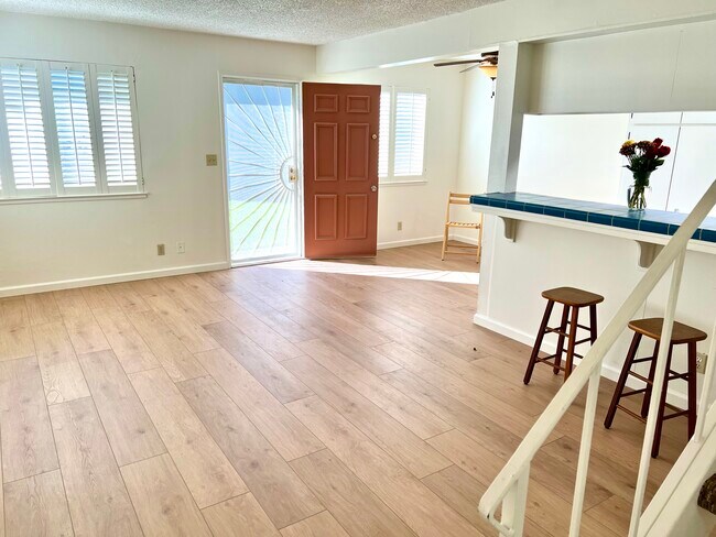 View of living room, breakfast bar and dining area with fan - 2468 Plata Ct