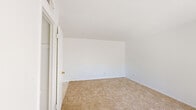 Located in El Paso, TX, this single-floor, 2-bedroom, 1-bathroom home offers a functional and efficiently arranged layout. The space is organized around a central hallway connecting all rooms, giving the floor plan a clean, practical flow.

The spacious primary bedroom features vaulted-style angled ceilings, a sliding closet, and warm neutral carpeting, creating a comfortable retreat. The second bedroom benefits from dual windows fitted with vertical blinds, allowing generous natural light to fill the room and offering views of the surrounding outdoor greenery.

The galley-style kitchen is bright and well-organized, featuring white cabinetry, wood-toned countertops, tile flooring, a gas range, and a full-size refrigerator. A window at the end of the kitchen brings in additional natural light. A dedicated hallway closet provides convenient storage near the entryway, which includes a built-in shelving rod and opens to carpeted living space.

The full bathroom is finished with white ceramic tile surrounding a full-size soaking tub with shower, complemented by a small window for natural ventilation. Throughout the home, white walls and light-toned carpeting maintain a clean, neutral aesthetic suited for easy personalization.
