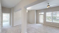 This well-designed 2-bedroom, 1-bathroom residence in Columbia, SC offers a comfortable and functional single-story layout. The open-concept living room is bright and spacious, featuring plush carpeting, neutral warm-toned walls, and a ceiling fan with light. Large windows and a glass-paneled entry door flood the space with natural light and provide views of the surrounding greenery, while a private balcony access adds an outdoor element to the living area.

The kitchen is a standout feature, showcasing rich dark cabinetry, granite countertops, a mosaic tile backsplash, and wood-look flooring. It is well-equipped with stainless steel appliances, including a microwave and range.

The generously sized primary bedroom is carpeted and bathed in natural light through dual windows overlooking lush outdoor scenery, and is complemented by a ceiling fan. A dedicated closet adds practical storage. The second bedroom is equally well-appointed, also featuring carpet, a ceiling fan, and its own closet. The bathroom includes a full tub-shower combination with tasteful tile surround. Two closets throughout the unit provide ample storage. The overall palette of soft neutrals creates a clean, cohesive ambiance throughout.