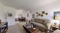 Located at 777 N Silver Springs Blvd in Wichita, Kansas, this single-floor, one-bedroom, one-bathroom residence offers a well-organized layout that makes efficient use of its intimate footprint. The open living and dining area serves as the heart of the home, featuring plush carpeting, a ceiling fan, and a large sliding glass door that floods the space with natural light while offering views of the outdoors. The living area provides a comfortable, welcoming atmosphere with neutral-toned walls and a relaxed, functional arrangement. Adjacent to the living room, the dining area accommodates a full-sized dining table and benefits from its own ceiling fan, making it ideal for everyday meals. The galley-style kitchen is thoughtfully equipped with wood-tone cabinetry, a full-size refrigerator, electric range, dishwasher, and tile flooring — designed to maximize every inch of available space. The carpeted bedroom is a quiet retreat, comfortably sized with a closet for storage and direct sightlines to the dining area. The bathroom features a wood-vanity with an integrated sink and textured walls. A hallway connects the main living areas to the private spaces, completing this practical and cozy single-level home.