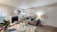 Located at 18175 Midway Rd in Dallas, Texas, this single-floor residence offers a thoughtfully designed layout that balances comfort and functionality. The living room serves as the heart of the home, anchored by a classic fireplace framed with a clean white mantle. Wood-look flooring runs throughout, adding warmth and cohesion to the space, while a textured ceiling adds a traditional architectural touch. Natural light filters in through slatted blinds, brightening the neutral-toned walls and creating an inviting atmosphere.

The kitchen features a peninsula-style counter with light speckled surfaces, white cabinetry, and black appliances including a range and microwave. A window above the counter allows additional natural light into the cooking space, and the open pass-through design keeps the kitchen connected to the surrounding living area.

The bedroom is a restful retreat, complete with a ceiling fan with light fixture, hardwood-style flooring, and a deep window ledge that brings in soft, diffused light. The room's neutral palette and textured ceiling complement the overall aesthetic of the home.

The bathroom is clean and efficiently arranged, featuring white cabinetry with ample overhead storage, a speckled countertop vanity, a large mirror with overhead lighting, and a shower-tub combination. Every detail reflects a practical and comfortable living environment.