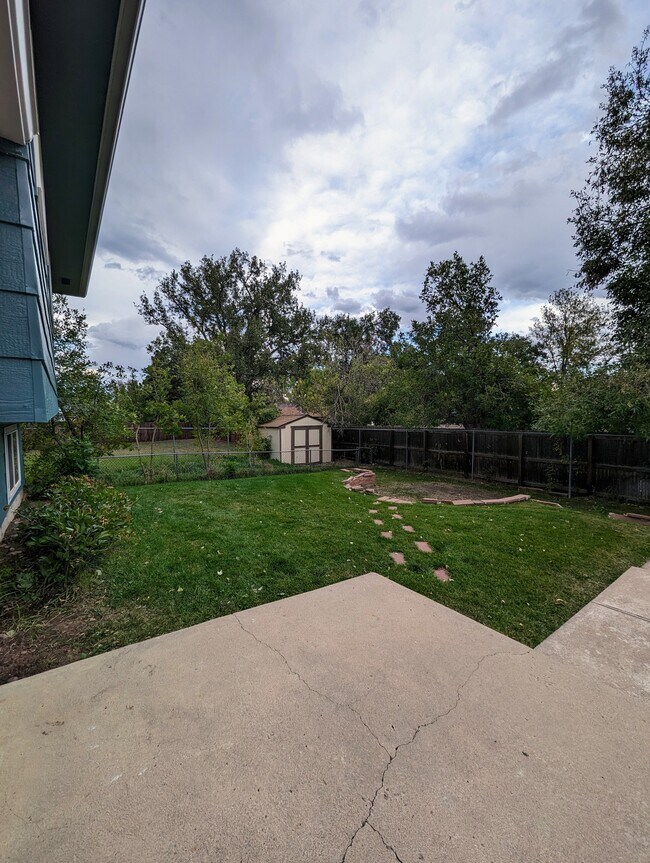 Backyard view with shed and gated garden area - 4666 S Garland Way