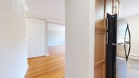 Located at 806 Morris Tpke in the desirable community of Short Hills, NJ, this well-appointed one-bedroom, one-bathroom residence offers a thoughtfully designed single-floor layout. Warm, richly toned hardwood floors flow continuously throughout the living areas and bedroom, creating a cohesive and inviting atmosphere.

The open living room and kitchen area is bathed in natural light courtesy of multiple windows that frame views of the surrounding greenery. Decorative crown molding and a structural column add architectural character to the space. The kitchen features warm wood cabinetry, dark stone countertops, and stone-look tile flooring, providing a functional and attractive workspace.

The bedroom offers generous proportions, complete with a wall of built-in closets that provide ample storage. Soft, neutral-toned walls complement the hardwood floors throughout.

The bathroom stands out as a highlights of the residence, showcasing floor-to-ceiling marble-look tile surrounding a soaking tub with shower, a sleek floating vanity with chrome fixtures, and a small window that brings in natural light — creating a clean, spa-like aesthetic.

Baseboard heating and wall-unit air conditioning ensure year-round comfort throughout this well-maintained Short Hills residence.