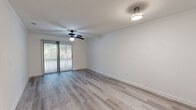 Located at 900 Dilworth St in Saint Marys, Georgia, this single-floor, one-bedroom, three-bathroom residence offers a clean and functional layout across a comfortable footprint. The open entryway leads down a bright hallway with light-toned luxury vinyl plank flooring that carries through the main living spaces. The living room is a generously sized area featuring a ceiling fan, crown molding, and a sliding glass door that opens to a private balcony, allowing natural light to fill the space and offering pleasant views of the surrounding greenery. A separate dining room provides dedicated space for meals and gatherings. The kitchen is well-equipped with rich, warm-toned wood cabinetry, dark granite countertops, a stainless steel sink, a dishwasher, and tile flooring — a combination that delivers both style and practicality. The bedroom is a comfortably sized retreat with plush carpeting and a window that brings in natural light. Three bathrooms feature tile flooring and vanities consistent with the kitchen's design aesthetic, providing ample convenience. Additional highlights include three closets for generous storage, a dedicated laundry room with washer hookups, and a hallway connecting the living spaces seamlessly throughout the home.