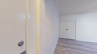 Located at 530 S Kingsley Drive in the Koreatown neighborhood of Los Angeles, this single-floor unit combines classic architectural character with updated modern finishes. Light hardwood-style flooring runs continuously throughout the space, creating a bright and cohesive aesthetic.

The entry hallway welcomes you with crisp white walls, crown molding detail near the ceiling, and a clean, minimalist feel that sets the tone for the rest of the unit. The hallway leads to a set of paneled double doors, adding a refined architectural touch.

The main living area is a standout, featuring an exposed red brick accent wall that lends warmth and historic character to the room. Crown molding frames the ceiling, and a ceiling fan provides both style and function. Natural light fills the space through double windows fitted with blinds.

A second well-proportioned room also features a ceiling fan, crown molding, and light-toned flooring, with an arched passageway adding a charming architectural detail.

The kitchen is outfitted with sleek gray cabinetry, dark granite-style countertops, a stainless steel sink, and light-toned flooring. Track lighting above adds a contemporary touch to the functional layout.

The bathroom showcases a striking black-and-white patterned tile floor that serves as a bold design centerpiece. A pedestal sink, soaking tub, classic subway tile surround, gold-toned fixtures, and a frosted window complete this well-appointed space.