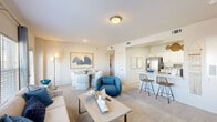 Located on E 121st St S in Broken Arrow, Oklahoma, this well-appointed single-floor residence offers three bedrooms and three full bathrooms. The open-concept layout connects the living room, dining area, and kitchen in a seamless flow, creating a bright and welcoming common space. The living room features plush carpeting, a sleek built-in electric fireplace, and large windows that invite natural light and neighborhood views. The kitchen is outfitted with white cabinetry, subway tile backsplash, stainless steel appliances including a French door refrigerator and gas range, and a marble-style countertop peninsula with bar seating. The primary bedroom is a comfortable retreat with a ceiling fan, carpeted floors, and a private en-suite bathroom featuring a marble-style vanity, bright vanity lighting, and a walk-in closet with wire shelving. Additional bedrooms offer similarly cozy carpeted spaces, ceiling fans, and access to well-appointed bathrooms, one of which includes a tub-shower combination. A dedicated entrance and hallway provide a clean transition into the living areas. Neutral tones and clean finishes throughout give the space a cohesive, move-in-ready aesthetic.