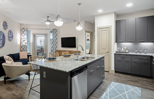 Kitchen and living area at The Alexa Luxury Apartments in Corpus Christi, TX. - The Alexa Luxury Apartments I & II