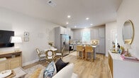 Located in Conroe, TX, this single-story 2-bedroom, 2-bathroom home offers a thoughtfully designed open-concept layout with warm, contemporary finishes throughout. Light wood-look flooring flows seamlessly across the living, dining, and kitchen areas, creating a cohesive and inviting atmosphere.

The kitchen is a standout feature, equipped with stainless steel appliances, gray shaker-style cabinetry, quartz countertops, a subway tile backsplash, and a peninsula with bar seating. A dedicated pantry adds practical storage, while a charming dining nook sits just adjacent to the kitchen.

The living room is bright and comfortable, featuring large windows with natural light and direct access to the private patio. Both bedrooms include ceiling fans and ample closet space. The primary bedroom is generously sized, highlighted by a bold botanical accent wall, large windows with a built-in bench, and an en-suite bathroom featuring a dual-sink vanity with blue cabinetry and quartz countertops. The second bathroom offers a clean, light-filled design with gray cabinetry and a window above the vanity. Additional conveniences include a dedicated laundry area, a hallway, and multiple closets throughout.