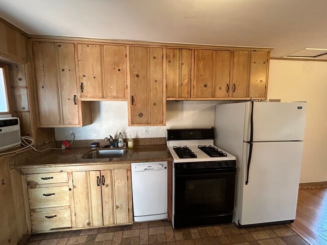 Sink, granite countertop, dishwasher, gas stove, fridge/freezer. - 1632 Live Oak Way