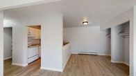 Located at 1300 Georgetown Blvd in Lansing, Michigan, this single-floor unit offers a practical and functional layout throughout. The living area is bright and open, featuring light wood-style flooring, neutral gray walls, and a baseboard heating system. Natural light filters in through a window with an outdoor view, lending a welcoming atmosphere to the space. A wall-unit air conditioner is also present in the living area for year-round comfort.

The kitchen is designed in a galley style and is equipped with white cabinetry, granite-style countertops, a double stainless steel sink with a modern faucet, a white electric range, and a full-size refrigerator. A pass-through counter connects the kitchen to the living area, creating an open feel between the two spaces.

The bedroom offers a comfortable footprint with light wood-style flooring, a baseboard heater, and a closet with an open rod, allowing for organized storage. Natural light enters through a window, keeping the room bright.

The bathroom includes a full-size tub and shower combination with classic tiled surround walls, complemented by a standard toilet and clean, straightforward finishes. Throughout the unit, consistent light wood flooring and a neutral color palette create a cohesive and clean aesthetic.