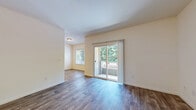 Located at 802 Camino Ramon in Danville, CA, this single-floor, 3-bedroom, 2-bathroom home offers a practical and comfortable layout. The living room is a bright, open space featuring wood-look plank flooring and a sliding glass door that opens onto a private balcony overlooking lush greenery, allowing natural light to fill the room throughout the day. The kitchen is efficiently designed with warm oak cabinetry, granite-look countertops, a double sink, recessed lighting, and a full suite of appliances including a stainless steel refrigerator, microwave, dishwasher, and range. The bedrooms are finished with soft carpeting and feature windows with blinds for natural light and privacy. The spacious primary bedroom is notably generous in size, complemented by a walk-in closet with dual hanging rods offering ample storage. The two bathrooms are cleanly finished, each featuring wood-look tile flooring, a vanity with a white countertop, and a shower-tub combination. A connecting hallway provides smooth access between all rooms. Neutral wall tones and clean finishes throughout give the home a bright, well-maintained ambiance suitable for a variety of living arrangements.