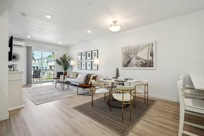 Large open floorplan layout accommodates barstool, a full dining set and living room furniture. - Holmes Park Townhomes