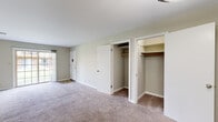 Located at 5334 Nottingham Dr in Evansville, Indiana, this single-story unit offers a practical and well-organized layout designed for comfortable everyday living. Neutral tones, clean white trim, and wall-to-wall carpeting in the living and sleeping areas create a cohesive, understated aesthetic throughout.

The galley-style kitchen is a functional highlight, featuring warm wood cabinetry with ample storage, dark laminate countertops, and tile flooring. Black appliances — including a refrigerator, electric range, microwave, and dishwasher — are all included, along with a double basin sink. A walk-in pantry or utility closet is accessible directly from the kitchen.

The living area is generously proportioned, offering sliding glass door access to an outdoor patio and a built-in closet for added storage. Two additional carpeted bedrooms provide comfortable accommodations; the larger room features dual closets and a sliding glass door, while the secondary bedroom includes a single window allowing natural light.

A dedicated bedroom elsewhere in the layout features two windows and open closet access. The bathroom is cleanly finished with a vanity, tub-shower combination, and tile flooring. Overall, the space offers a straightforward, move-in ready environment with practical storage solutions throughout.