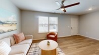 Located at 11517 E 38th St in Indianapolis, IN, this well-appointed one-bedroom, one-bathroom unit offers a thoughtfully designed single-floor layout with modern finishes throughout. Warm wood-look flooring flows seamlessly across the main living areas, lending a cohesive and inviting feel to the space.

The open-concept kitchen and living room form the heart of the home. The kitchen features granite countertops, white shaker-style cabinetry, a double-basin sink, and a full suite of black appliances, including a refrigerator, range, microwave, and dishwasher. A peninsula provides additional prep and dining space. The adjacent living area is bright and comfortable, complemented by a ceiling fan and room for a generous seating arrangement.

The bedroom is a comfortable retreat with plush carpeting, a ceiling fan, and large windows that allow natural light to fill the room. A dedicated walk-in closet with wire shelving and hanging rods offers ample storage. The full bathroom continues the granite countertop theme, paired with a white vanity and wood-look flooring.

Additional highlights include a dedicated laundry room with a full-size washer and dryer, and clean, neutral wall tones throughout that create a bright and move-in-ready atmosphere.