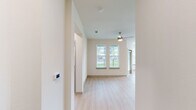 This well-designed 2-bedroom, 2-bathroom single-story residence at 8025 Monty Stratton Pkwy in Greenville, TX offers a clean, modern aesthetic with thoughtful details throughout. Light wood-style flooring flows seamlessly across the entire unit, creating a cohesive and bright atmosphere. The open-concept kitchen serves as the heart of the home, showcasing grey shaker-style cabinetry, granite countertops, a central island with pendant lighting, stainless steel appliances, and a subway tile backsplash — all designed for both functionality and style. The living area extends naturally from the kitchen and features a ceiling fan, two large windows, and a glass door that invites natural light and outdoor views. Both bedrooms are comfortably proportioned, each equipped with a ceiling fan and windows overlooking the surrounding greenery. The primary bedroom connects to a dedicated en-suite bathroom, while the second full bathroom features a tiled tub-shower combination, wood-style flooring, and a granite-topped vanity. Additional features include two closets, two hallways for convenient circulation, and recessed lighting. The overall ambiance is clean, contemporary, and move-in ready.