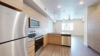 Located at 103 W 4800 N in Provo, Utah, this efficiently designed single-floor studio offers a thoughtfully arranged open-concept layout that maximizes every square foot. Light wood-tone vinyl plank flooring flows continuously throughout the space, creating a cohesive and clean aesthetic.

The kitchen is a standout feature, showcasing flat-front light wood cabinetry extending floor to ceiling for ample storage, granite-look countertops, and a full suite of stainless steel appliances including a refrigerator, electric range, built-in microwave, and dishwasher. Pendant lighting over the peninsula adds a modern, polished touch.

The open living area benefits from natural light through a large window and is equipped with a ceiling fan, recessed lighting, and a textured ceiling. The neutral, warm-toned walls and light flooring contribute to a bright and airy atmosphere.

The full bathroom mirrors the kitchen's design language, featuring the same light wood cabinetry, granite-look countertop, a wide vanity mirror, and a tub/shower combination with brushed nickel fixtures. A dedicated closet and a well-lit entry hallway with smart lock access round out the space, offering functional storage and a secure, welcoming entry point.