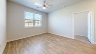 Located in San Antonio, TX, this well-appointed single-story residence offers 2 bedrooms and 2 bathrooms within a thoughtfully designed floor plan. Wood-style flooring flows throughout, complementing the clean, neutral color palette that gives the space a bright and cohesive feel.

The kitchen serves as the heart of the home, featuring a central island with granite countertops, a stainless steel appliance suite including a French door refrigerator, dishwasher, and range with microwave, plus ample cabinetry and a built-in pantry with open shelving for generous storage.

Both bedrooms are comfortably sized with large windows that invite natural light and neighborhood views. Ceiling fans provide additional comfort. Each bedroom benefits from its own dedicated closet with wire shelving systems for organized storage.

The two bathrooms are well-finished, each showcasing granite-topped vanities with gray shaker-style cabinetry, large mirrors, and wood-style flooring. The primary bathroom includes a soaking tub with tiled surround, while the secondary bathroom offers a tiled walk-in shower. Both bathrooms provide direct access to their respective walk-in closets, adding a practical and functional touch to the overall layout.