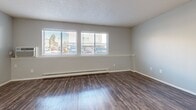 Located at 960 S Dexter St in Denver, CO, this single-floor, 2-bedroom, 1-bathroom unit offers a practical and well-organized layout across a comfortable footprint. The living room is bright and open, featuring dark hardwood-style flooring, a textured ceiling, baseboard heating, and large windows that invite natural light and outdoor views. The galley-style kitchen is efficiently designed with white cabinetry lining both sides, a stainless steel sink, white appliances including a range and refrigerator, and matching hardwood-style flooring that ties the common areas together. Both bedrooms are carpeted and neutral in tone, with soft gray walls, textured ceilings, and natural light filtering through blinds. The primary bedroom provides a generous layout and includes a mirrored sliding closet. The second bedroom also features a closet and ample space. The bathroom is clean and functional, appointed with a white vanity, brushed nickel fixtures, framed mirror, and louvered medicine cabinet. Additional highlights include four closets throughout for abundant storage, a dedicated laundry area, and a connecting hallway that ties the layout together seamlessly. The unit's neutral palette and consistent finishes create a cohesive, move-in-ready atmosphere.