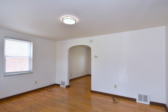 Spacious Living Area with original hardwood flooring throughout - 210 E Garden Rd