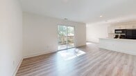 Located at 325 W Parkwood Dr in Dayton, Ohio, this thoughtfully updated 2-bedroom, 2-bathroom single-story home offers a clean, modern aesthetic throughout. Light-toned luxury vinyl plank flooring runs consistently across every room, creating a bright and cohesive feel.

The kitchen showcases contemporary gray cabinetry with bold gold hardware, white quartz-style countertops, subway tile backsplash, and a full suite of black appliances including a range, over-the-range microwave, and dishwasher. It opens conveniently toward the living area, which is bathed in natural light from a large sliding glass door leading to a wooden deck with outdoor views of mature trees.

The spacious primary bedroom features recessed lighting and louvered closet doors, while the second bedroom includes a ceiling fan with light fixture and a window overlooking the neighborhood. A stacked washer and dryer unit is conveniently tucked within the bedroom area.

Both bathrooms are finished with large-format marble-look tile flooring and wall tile. The primary bath includes a tub-shower combo with fully tiled surround and matte black fixtures, while the second bath offers a standalone walk-in shower, also with matte black hardware. Crisp white walls and clean lines carry throughout, giving the entire home a fresh, move-in-ready appearance.