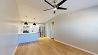 Located at 205 Warrior Dr in Murfreesboro, TN, this well-designed one-bedroom, one-bathroom unit offers a thoughtfully laid-out single-floor plan with modern finishes throughout. Light hardwood flooring flows seamlessly across every room, creating a cohesive and clean aesthetic.

The open-concept kitchen and living area serves as the heart of the unit. The kitchen is outfitted with crisp white shaker cabinetry featuring matte black hardware, white quartz countertops, a subway tile backsplash, and a full suite of stainless steel appliances including a range, dishwasher, and French door refrigerator. A kitchen island provides additional prep and seating space, while two pendant lights with black dome shades add a modern accent. A ceiling fan with integrated lighting anchors the adjoining living area, which receives natural light through a front-facing window.

The bedroom is a comfortable, quiet retreat with windows that invite natural light and a dedicated closet. Neutral gray wall tones complement the light flooring throughout. The bathroom features a white vanity with quartz countertop, an undermount sink, matte black fixtures, and a framed mirror, maintaining the unit's consistent modern style. Hallways connect the spaces efficiently, completing a practical and attractive floor plan.