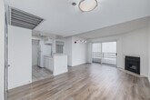 Located at 1441 Midvale Ave in the heart of Westwood, Los Angeles, this one-bedroom, one-bathroom unit offers a well-organized single-floor layout that makes efficient use of its space. The open-concept living and dining area is anchored by light wood-style flooring throughout and features a classic fireplace with a black surround, adding a focal point to the room. Large sliding glass doors flood the space with natural light and open to a private balcony, providing an airy, bright atmosphere. The kitchen is thoughtfully designed with white cabinetry, light stone countertops, a stainless steel sink, and white appliances including a gas range, dishwasher, and refrigerator, all set on tile flooring. The bedroom is a well-proportioned retreat featuring the same warm wood-style floors, a natural window for additional light, and a mirrored sliding-door closet that enhances the sense of space. Direct access to the bathroom is available from the bedroom. The bathroom includes a white vanity with a stone-topped countertop, a large mirror with vanity lighting, and a shower enclosure. Throughout the unit, clean white walls and a neutral palette create a bright, move-in ready environment suited for comfortable urban living in one of LA's most desirable neighborhoods.