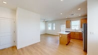 Located at 5200 Old Farm Rd in Bakersfield, CA, this single-story 3-bedroom, 2-bathroom home offers a well-designed layout with a bright, open feel throughout. The living room and kitchen share an open-concept space anchored by light wood-look flooring and recessed lighting. A ceiling fan keeps the living area comfortable, while multiple windows with blinds allow natural light to fill the space. The kitchen is well-appointed with warm-toned wood cabinetry, white subway tile backsplash, white quartz countertops, a center island, and a full suite of stainless steel appliances including a gas range, microwave, dishwasher, and refrigerator. A door provides direct exterior access from the kitchen. The bedrooms feature plush carpeting, and several rooms include ceiling fans and windows with natural light views of the surroundings. One bedroom offers light wood flooring and a bright window overlooking outdoor greenery. The primary bedroom is generously sized and is complemented by a dedicated walk-in closet with built-in shelving and hanging rods. Both bathrooms are finished consistently with wood-toned vanities, white countertops, and tub-shower combinations with clean white tile surrounds and light wood flooring, delivering a cohesive and functional aesthetic throughout.