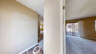 This single-floor residence in San Ramon, California offers a well-organized layout with a cohesive neutral color palette throughout. The entryway transitions from wood-look vinyl flooring into carpeted living areas, establishing a clear division between functional and relaxing spaces.

The living area is highlighted by a ceiling fan with light fixture, a window that draws in natural light, and a pass-through granite countertop connecting to the kitchen. The kitchen is fitted with light wood cabinetry, granite countertops, stainless steel appliances including a refrigerator and range, a built-in dishwasher, and wood-look vinyl flooring, providing a clean and functional workspace.

The bedrooms are generously sized with plush carpeting, ceiling fans, and ample natural light from multiple windows. One bedroom features a sliding glass door leading to an outdoor area, while another includes a walk-in closet. Both bathrooms are equipped with wood-look vinyl flooring, granite-topped vanities with light wood cabinetry, and full bathtub-shower combinations. The overall ambiance is bright, neutral, and move-in ready.