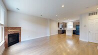 Located at 2758 Iowa Dr in Fort Collins, Colorado, this three-bedroom, two-bathroom home spans three well-proportioned floors, offering a functional and comfortable layout. The ground level features a spacious attached garage with ample storage and direct interior access, along with a utility area. The main living floor showcases gleaming hardwood floors throughout the open-concept living room and kitchen. The living room is bright and welcoming, anchored by a classic brick fireplace and large windows that invite abundant natural light. The modern kitchen is appointed with dark wood cabinetry, a tile mosaic backsplash, light quartz countertops, black appliances, and a central island—ideal for both cooking and casual dining. A convenient half-bath is also located on this floor. The upper floor is dedicated to the three bedrooms, each carpeted for comfort and equipped with ceiling fans. The spacious primary bedroom includes a walk-in closet, while the secondary bedrooms feature built-in closets with panel doors. The full bathroom on this level offers a clean, white tub-shower combination with tile flooring. Clean lines, neutral tones, and recessed lighting throughout give the home a fresh, move-in-ready feel.