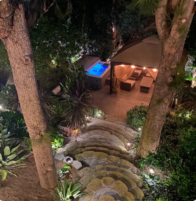 Backyard spa and gazebo at night - 4050 Davana Rd