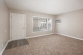 Located at 1921 W La Veta Ave in Orange, CA, this single-floor, one-bedroom, one-bathroom unit offers a practical and comfortable layout. The living room is generously sized, featuring warm beige carpet, neutral-toned walls, a large window that invites natural light, and a direct access door. A ceiling fan with lighting is also present, enhancing comfort year-round. The space flows into a hallway that connects the main living areas to the bedroom and bathroom. The combined dining room and kitchen is equipped with white cabinetry, light-toned countertops, a gas range, refrigerator, and a double-basin sink beneath a window. Light wood-style flooring grounds the kitchen and dining area with a clean, cohesive look. The bedroom is well-proportioned, featuring plush carpeting, a ceiling fan with light fixture, a window with blinds, and a built-in closet with sliding doors. Additional storage is provided through multiple closets and a pantry distributed throughout the unit. A hallway connects all areas and includes access to the electrical panel. The textured ceilings and consistent neutral palette throughout lend the unit a simple, tidy aesthetic well-suited for everyday living.
